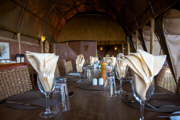 Empty beautiful table ready for the evening dinner inside a lodge in Moremi Nature Reserve. Botswana 2010 (Selective focus)