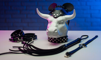 statuette of a white metal bull in a leather mask and accessories for BDSM games