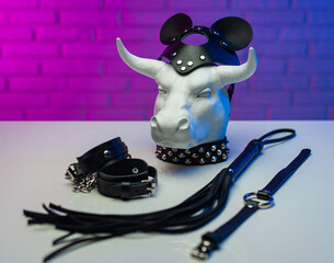 statuette of a white metal bull in a leather mask and accessories for BDSM games