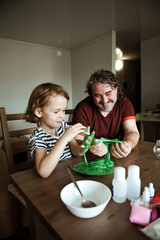 Father and son make slime at home. Homemade experiments.