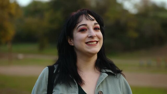 youth, confidence - young smiling woman looks at camera with a complicit look