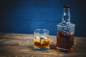 bottle of whiskey with a glass