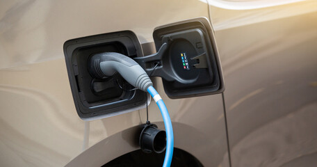 Close-up of an electric car with connected cable 