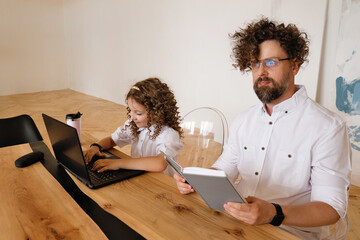 Father And Child Using Laptop For Homework Stay at Home During Pandemic Lockdown. Face Surprised Man Glasses. Hometask Time.