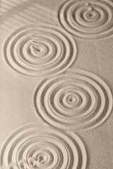 Fototapeta na wymiar Sand surface texture with circles and shadows, for relaxation and spiritual harmony