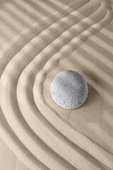 Fototapeta na wymiar Smooth lines on the sand and round stones in the rock garden, for relaxation and spiritual harmony