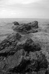big rocks in the sea splashed by the waves in Port Dickson beach Malaysia
