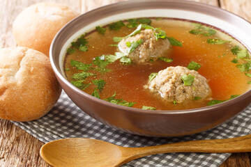 Tasty Liver dumplings added to broth make a wonderful authentic German soup close-up in a plate on...