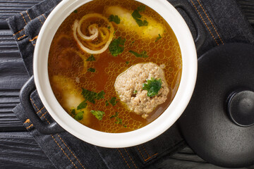 Rindsuppe Traditional Soup From Vienna, Austria close-up in a saucepan on the table. horizontal top view from above