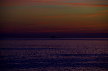 Sky on fire during sunrise or sunset twilight over the Mediterranean Sea with mountain coast...