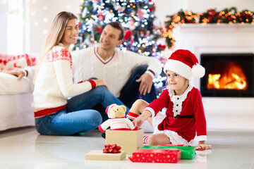 Family at Christmas tree. Parents and kids on Xmas