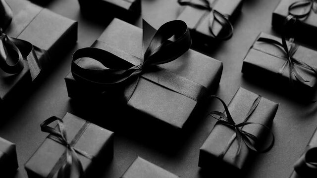 Elegant black Christmas theme. Wrapped gifts in black matte paper with ribbon