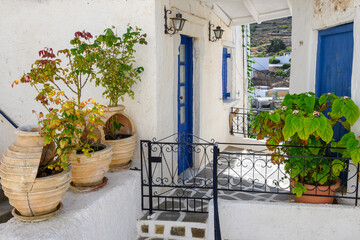Fototapeta na wymiar Street decorated with pots in Lefkes village on Paros Island, Cyclades, Greece