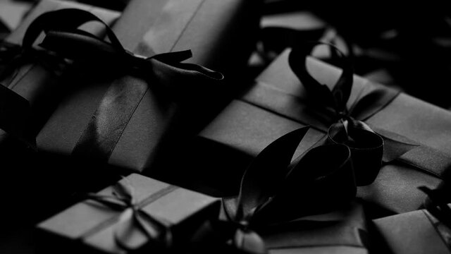 A pile various size black boxed gifts placed on stack. Christmas concept.