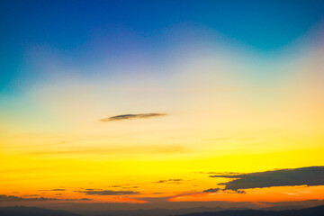Colorful cumulus sunset sky clouds with sun setting down