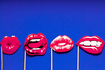 different shapes of female pink sexy lips in the form of a kiss on a blue background