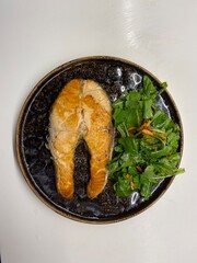 home cooked salmon fish with organic salad