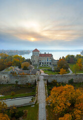 Fototapeta na wymiar Castle of Tata city in Hungary. Amazing water fort next to Old lake. Built in 13th century. Beautiful dramatic sunrise view.