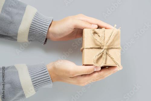 Top view, Christmas gift box cardboard in hands female for background new year, mother's day, anniversary, birthday, party and congratulation get a degree.