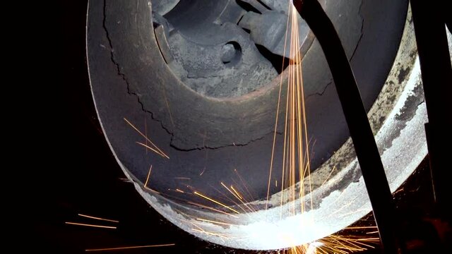 Technological process of applying thermal barrier protective coatings on elements of hot engine parts. Aviation. Repair of gas turbine engines. Sparks of hot metal close up. 