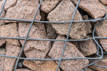 The rock behind the steel mesh design, protect