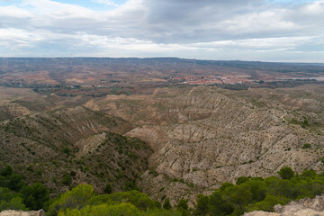Views of the Village of Maria de Huerva and the semi-desert valley with some pine trees from a nearby ravine