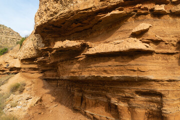 Weathered red sandstone wall with curious shapes