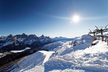Mountain Landscape of a sunny day on snow sky lopes on Italian Dolomiti, San Martino di Castrozza, Tognola Top with sun, the ski lift