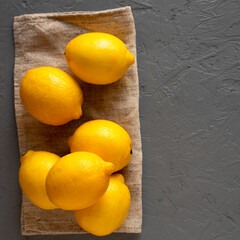 Ripe Yellow Organic Lemons on gray background, top view. Flat lay, overhead, from above. Space for text.