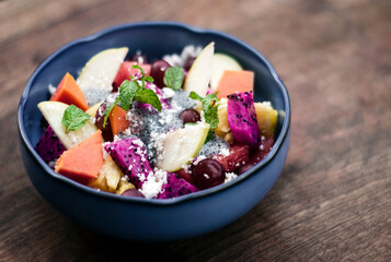 exotic mixed tropical asian fruit salad in bowl outdoors