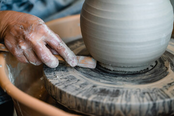 Potter making ceramic pot on the pottery wheel