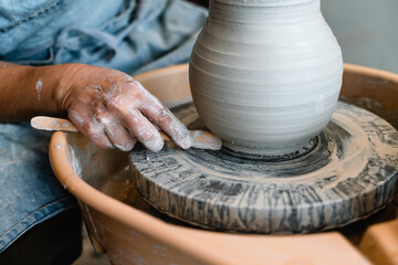 Potter making ceramic pot on the pottery wheel