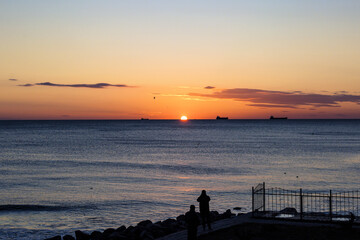 blue sea and clouds in the sky, sunrise on the horizon
