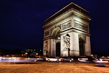 Fototapeta na wymiar View of famous Arc de Triomphe in Charles de Gaulle square at night in Paris, France