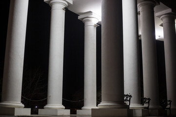 Illuminated columns with white light. Many columns on the house