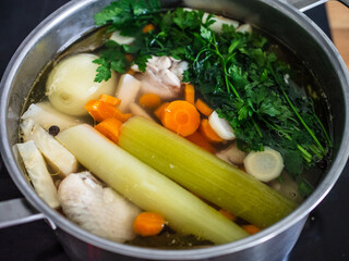 Broth - boiling chicken soup in pot
