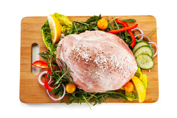 Fresh raw pork ham on cutting board on white background
