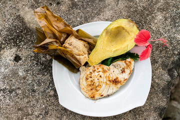 tuna fish plate with avocado and flower decoration in tropical holidays 