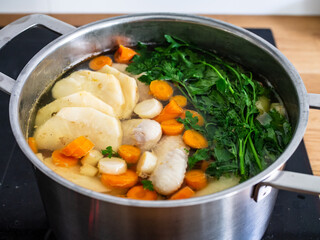 Broth - boiling chicken soup in pot
