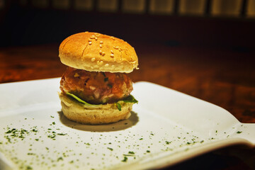 Mini hamburger in bar food skewer on wooden table
