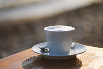 a cup of cappuccino in a cafe near the sea