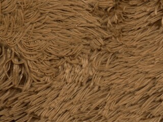 The texture of the doll fur is brown