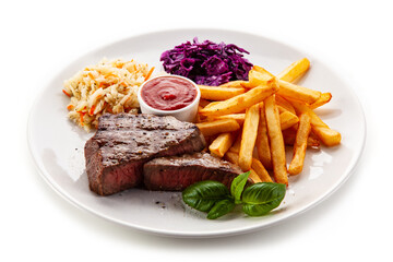 Grilled beef steak with french fries and vegetable salads  served on white background 