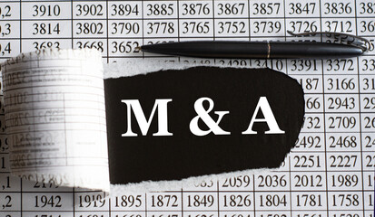 M&A is the word behind torn office paper with numbers and a black pen.