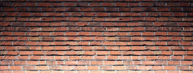 Interior brick wall construction background with lower light.