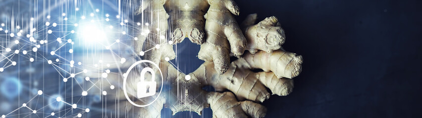 Ginger root whole and sliced. Ginger tea with lemon on the dark background. Fresh ginger root on...