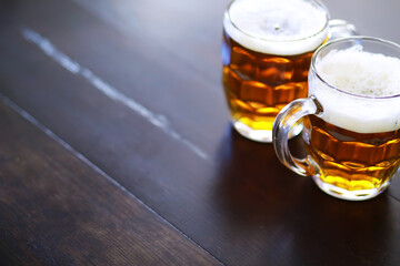 Glass of fresh beer on a wooden table. Lager beer mug on stone table. Top view with copy space