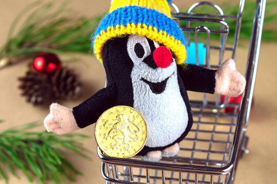 Czech Republic, Prague-2020 November: Czech mole doll in shopping cart with Christmas decorations.