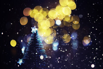 Winter holiday background with frozen fir, glitter lights, bokeh. Christmas and New Year holiday background with copy space.