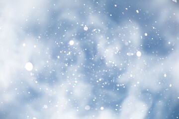 Fototapeta premium blue snowfall bokeh background, abstract snowflake background on blurred abstract blue